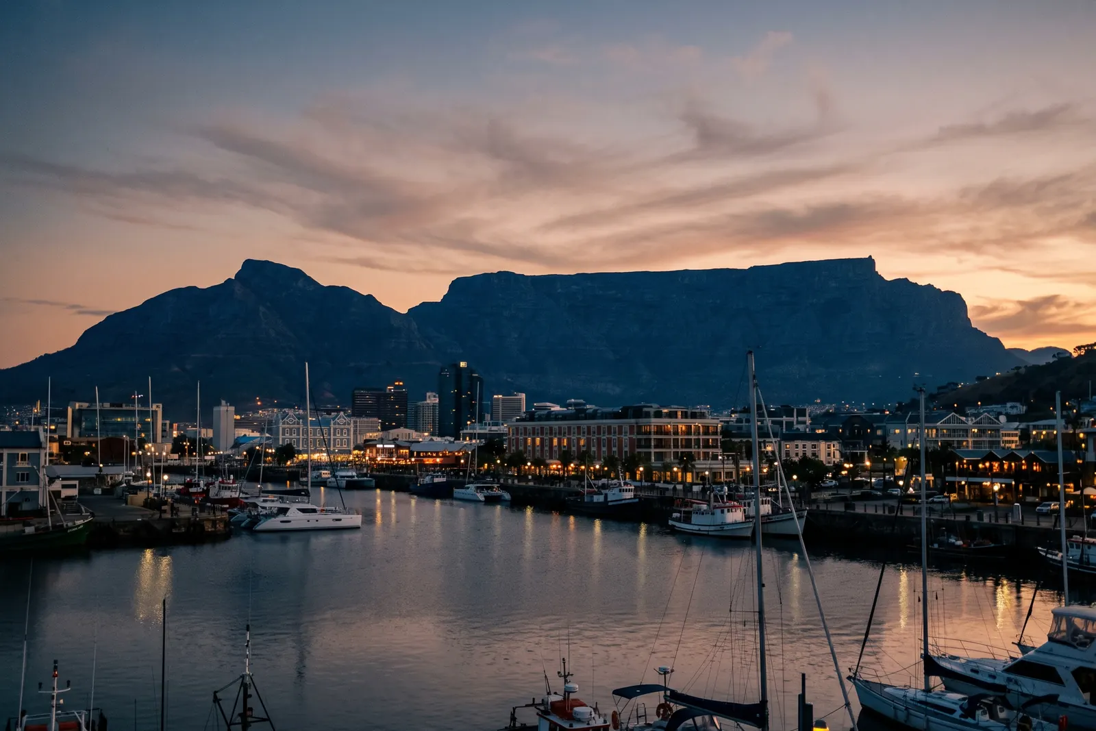 Table Mountain at dusk from the waterfront, lights coming on below
