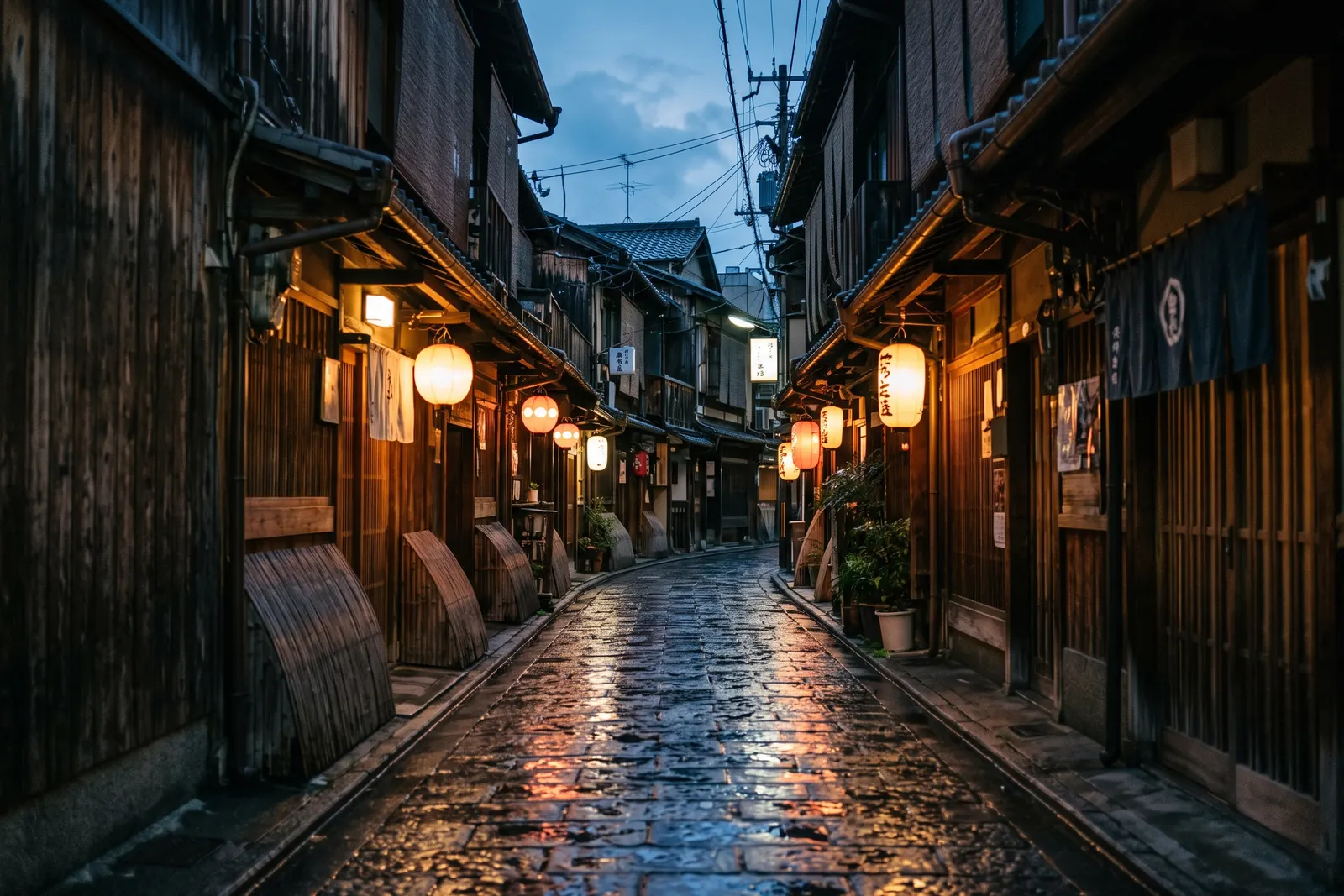 Tokyo lane at dusk, paper lanterns and neon reflected on wet paving